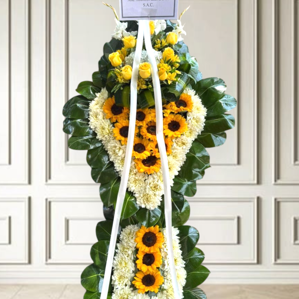 Cruz fúnebre con girasoles y rosas